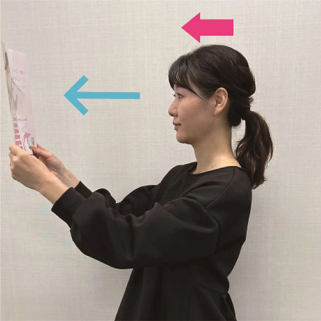 よくない例：書類を目の高さまで持ち上げて見ている女性